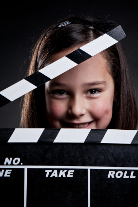 Image of girl with clapper for Digital Video Camp from August 6th through August 17 at Montgomery Community Media