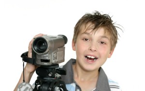 Image of boy with video camera for Digital Video Camp at Montgomery Community Media from August 6 to August 17 2012