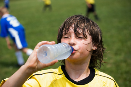 Boy drinking water after soccer