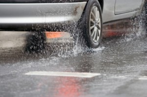 Image of car driving through heavy rain