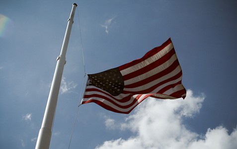 image of flag flying at half mask