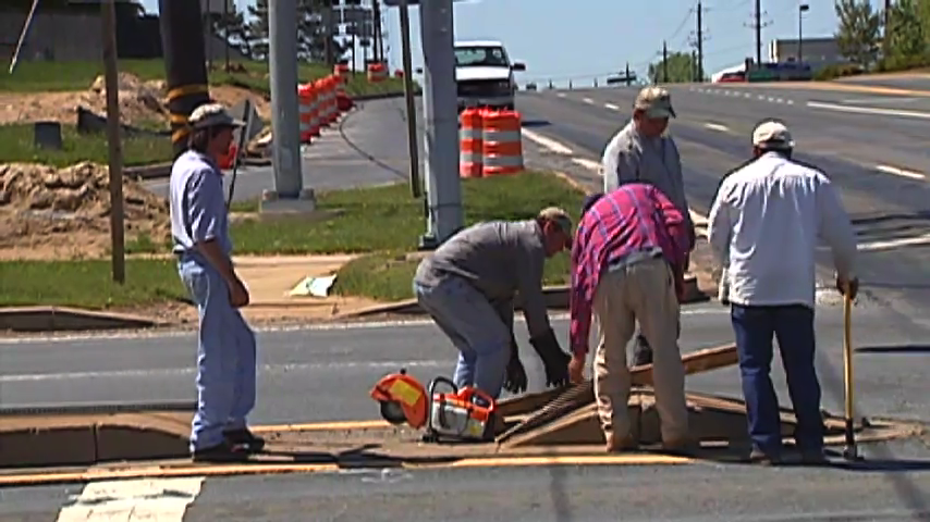 Construction workers fixing road