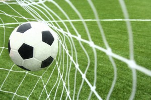 image of a soccer ball hitting the net