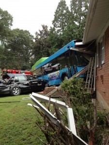 Image of Ride On Bus and taxi crashed into a house