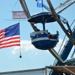 Image of fair ride with flag in background