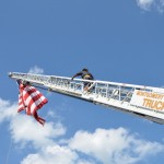 A lone firefighter ascends the ladder above the Fair