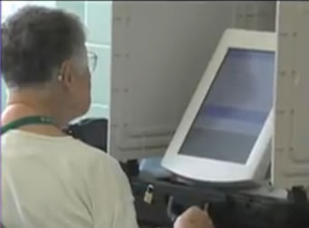 woman voting at voting machine