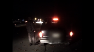 Police stop car at alcohol checkpoint