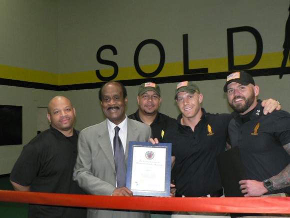 Montgomery County Executive Isiah “Ike” Leggett presents a county certificate commemorating the grand opening of the “Soldierfit Fort Gym” on May 31, 2013. Pictured is Russell Duvall, Soldierfit Executive Officer; Montgomery County Executive Isiah “Ike” Leggett Geraldo Martin, Soldierfit General Manager and Dave Posin & Danny Farrar, Soldierfit Founders/Owners (l:r).  Photo | Laura Rowles