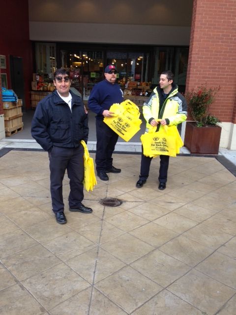 Firefighters from Rockville Fire Station #3 handing  out pedestrian safety shopping bags.  Photo | MCFRS <