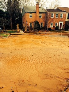 A portion of the parking lot at Shady Grove Village is covered by mud after the water main break.