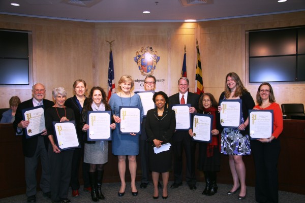 At the ceremony were Silver Spring civic and business leaders, left to right: Mel Tull, Helen Nolan, Connie Rhind Robey, Stephanie Helsing, Jane Redicker, Silver Spring Regional Center Director Reemberto Rodriguez, Councilmember Cherri Branson, Bruce Lee, Rebecca Silvestre, Laura Alin and Alla Shtipelman.