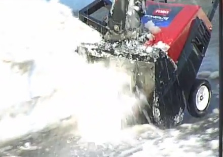 person operating snowblower