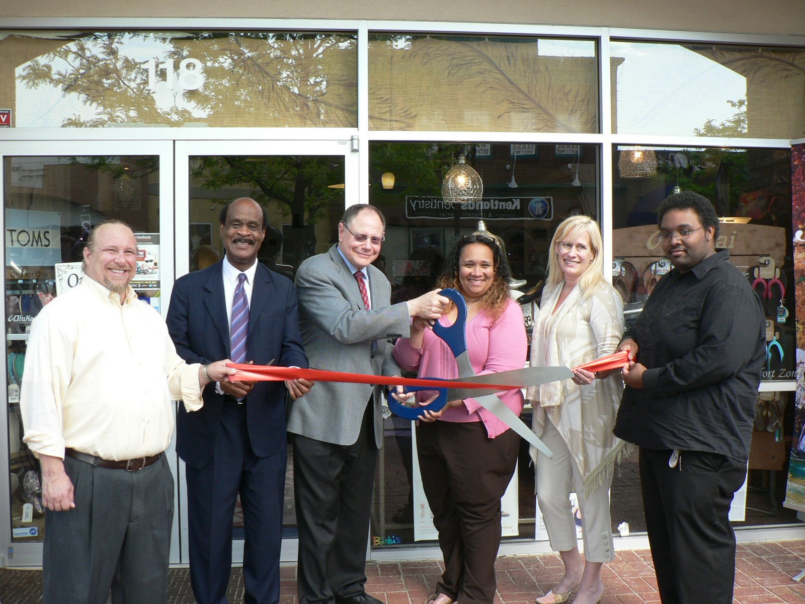 photo of Lewis Nordan, Montgomery County Executive Isiah “Ike” Leggett, City of Gaithersburg Mayor Sidney Katz, Jo’s Comfort Zone Owner JoAnn Epps, GGCC Board Member & My Realty Team Owner Ibi Sofillas and Julian Hassan at the Gaithersburg-Germantown Chamber conducted Ribbon Cutting Ceremony for Jo’s Comfort Zone in the Kentlands on May 12, 2014.