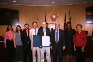 photo of At the ceremonies in Rockville were, left to right: Pam Holland, Erin Fiaschetti and Michael Rosenthal of A Wider Circle; Councilmember Roger Berliner; A Wider Circle founder Mark Bergel; Council Vice President George Leventhal; Chanel Giles and Pam Feinstein of A Wider Circle.
