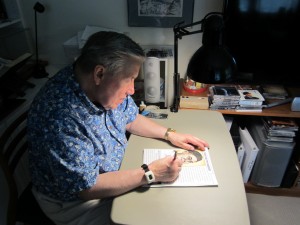 photo of Rev. Jim MacDonell at his drawing board.