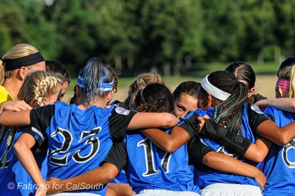 photo of Girls U13 Surf Academy team gather for a pregame moment - and I caught one girl with her eyes open