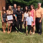 photo of Eva, Commander David Gillespie, Officer Gamard, and Eva’s family