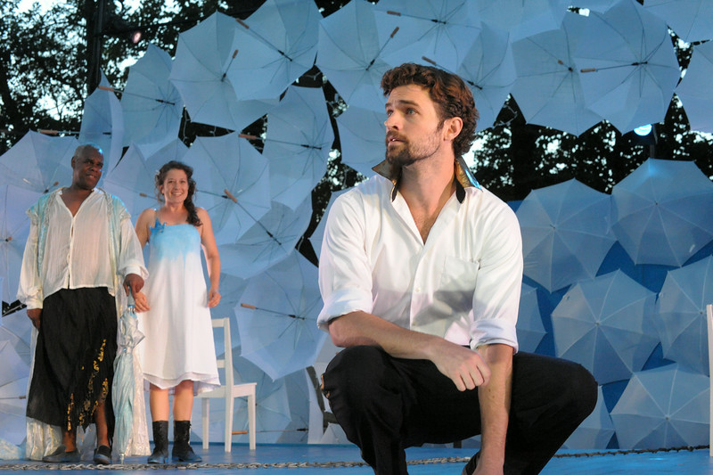 Photo of Prospero (Craig Wallace) and his daughter Miranda (Leah Filley) look on as Ferdinand (Alexander Korman) laments his father's fate in Olney Theatre Center's production of THE TEMPEST.