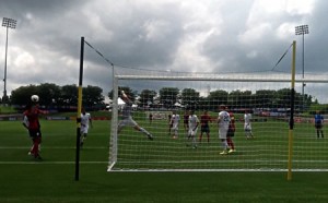 photo of youth soccer game from behind the goal net