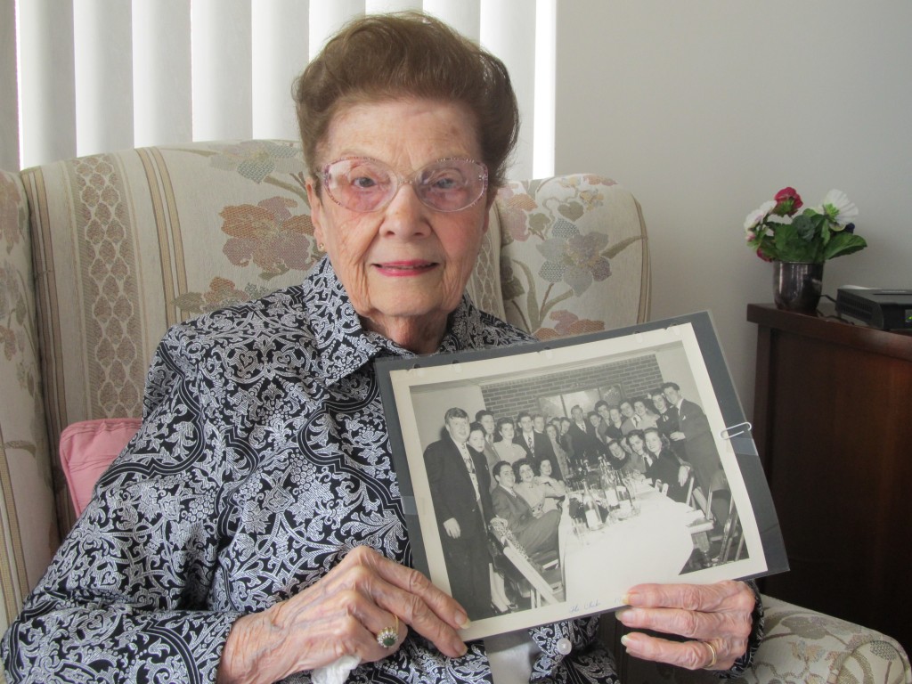 Jo Fannon, a resident of Riderwood retirement community, holds a photo of the Sub Deb Club and their significant others at the time.  The picture was taken in 1946, following World War II, at a dinner party at the Crossroads Restaurant in Bladensburg, Maryland.