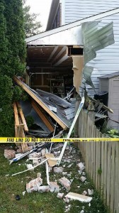 photo of damage to home after being struck by a car