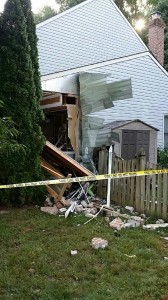 photo of damage to home after being struck by a car
