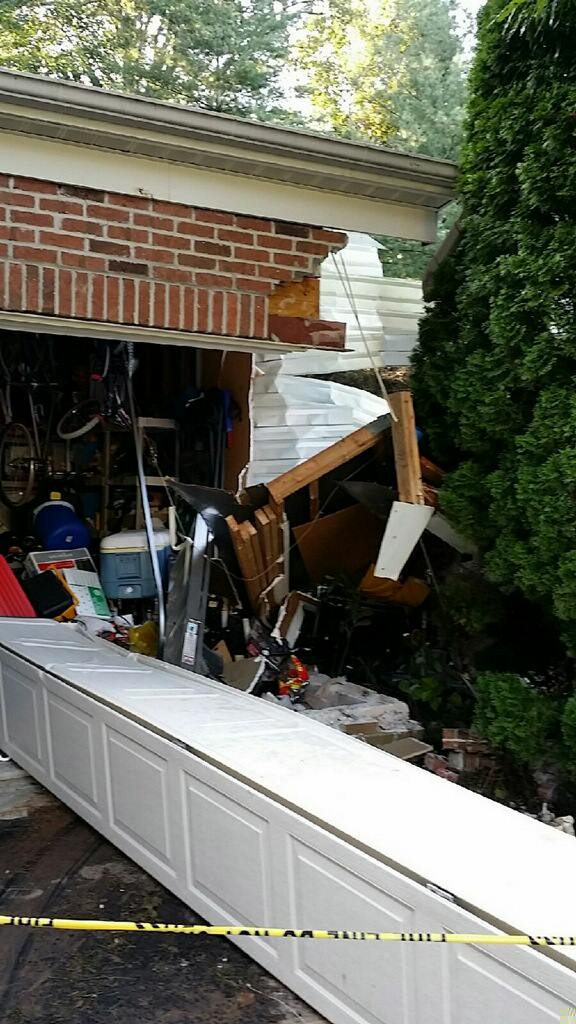 photo of damage to home after being struck by a car