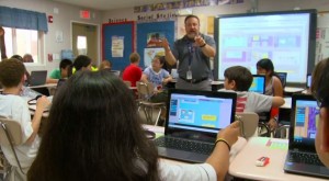 photo of MCPS teacher and students using new chrome books