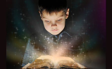 photo of boy reading from book