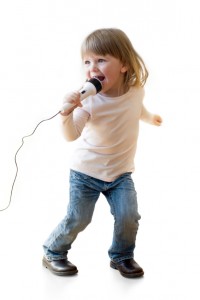 photo of toddler singing into a microphone