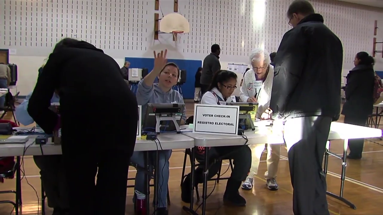photo of election workers helping at polling place
