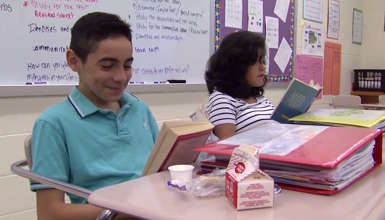 photo of students reading and eating breakfast