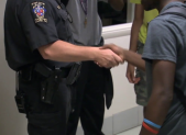 photo of school resource officer shaking hands with student