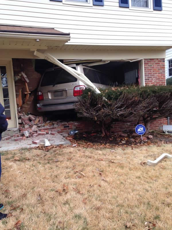 photo of car crashed into a house