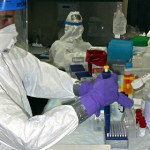 photo of Zalgen lab technician performing tests in protective gear