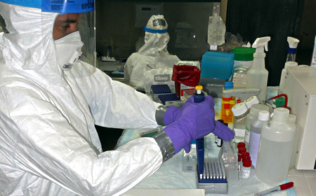 photo of Zalgen lab technician performing tests in protective gear