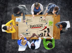 photo of group at conference table working on ideas