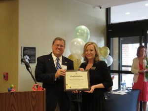 (l:r) City of Gaithersburg Mayor Jud Ashman presents Leila Beltramo, Director of Sales, Hampton Inn & Suites - Washington, DC North - G'burg, with a proclamation claiming June 12, 2015 as “Homewood Suites Day” at the official Grand Opening / Ribbon Cutting Ceremony of the new Homewood Suites Gaithersburg held on June 12, 2015.  (photo credit: Laura Rowles, GGCC Director of Events & Marketing)