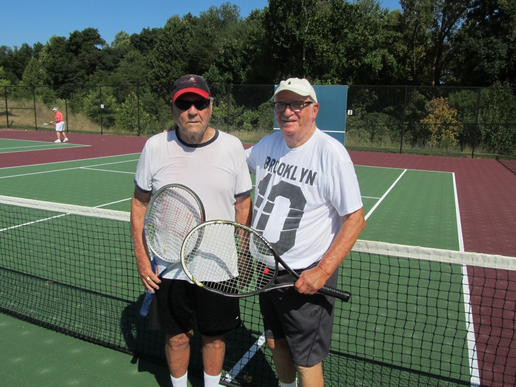 Ed Milligan (L) and Joel Sarnoff (R), are pictured following their victory in the championship match in men’s doubles division.  The Riderwood residents competed in the Annual Erickson Living Tennis Tournament in Silver Spring on September 9.