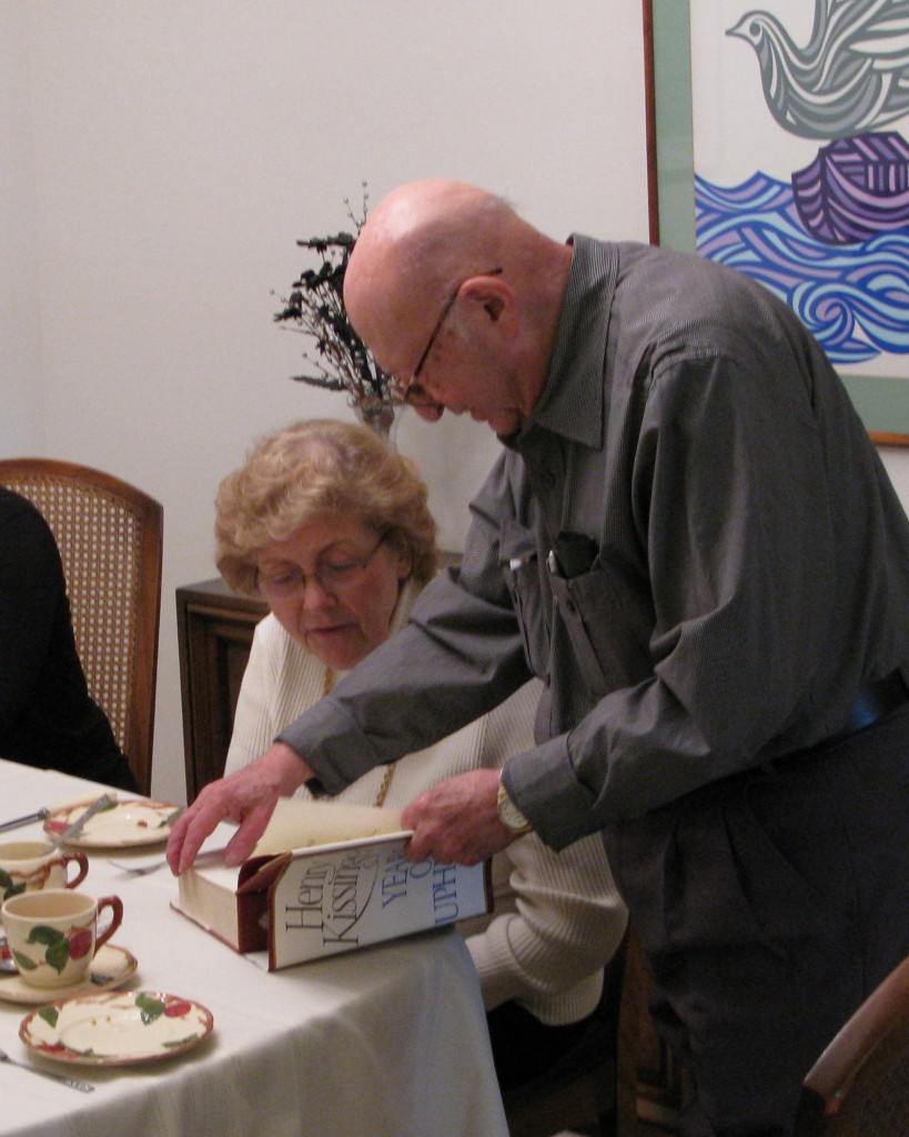 Photo of Harry showing book to a friend