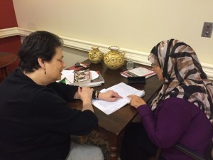Norma (left) works with Mina (right) on her reading skills