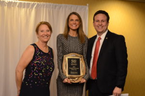 Brooke Bruch, Client Relations Manager with Contemporaries, Inc., (center) is awarded the Gaithersburg-Germantown Chamber’s 4th Annual Young Professional of the Year Award by Jonathan Sachs (right) of Adventist HealthCare Shady Grove Medical Center & the Chamber’s Executive Director Marilyn Balcombe (left) at the Chamber’s Annual Celebration Dinner on December 8, 2016.  (Photo Credit: John Keith Photography)