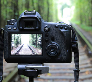 Abstract DSLR Camera on railway in forest; Shutterstock ID 327122660