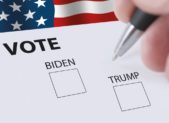 feature vote biden trump presidential vote ballot with a blurred hand holding a pen and picture-id1268054264